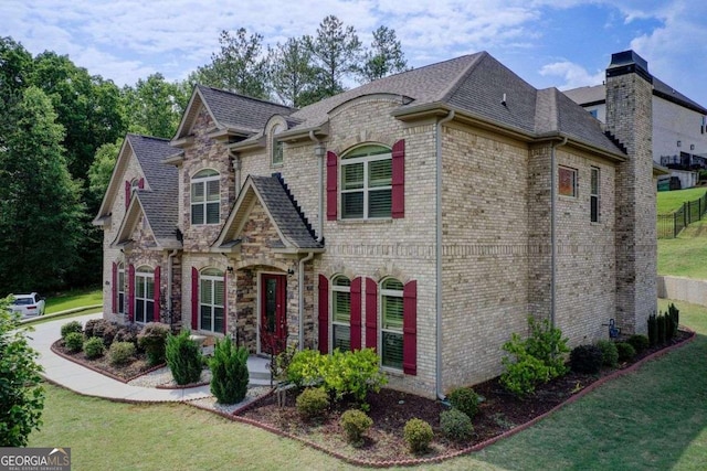 332 Warwick Pl, Mcdonough, GA 30253 - view of front of property with a front lawn, brick siding, and roof with shingles