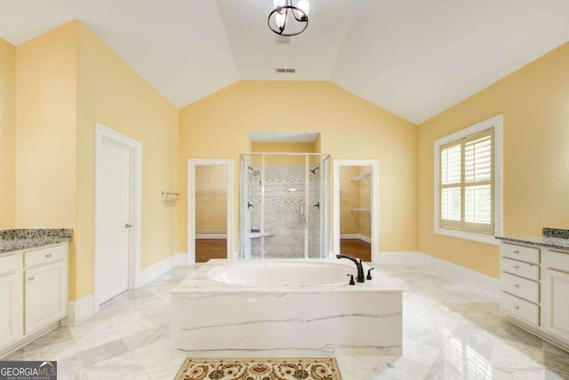 332 Warwick Pl, Mcdonough, GA 30253 - bathroom featuring vanity, a shower stall, a garden tub, a spacious closet, and baseboards