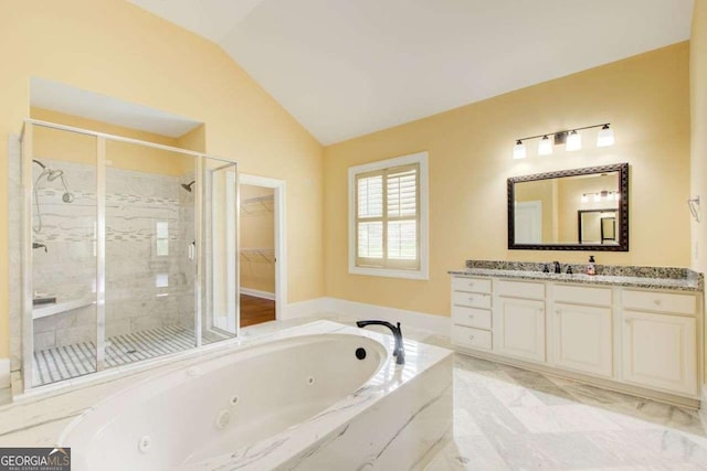 332 Warwick Pl, Mcdonough, GA 30253 - bathroom featuring a shower stall, lofted ceiling, vanity, and a jetted tub