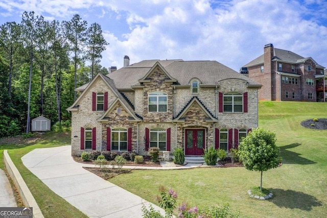 332 Warwick Pl, Mcdonough, GA 30253 - french country style house with french doors, a front yard, a chimney, and stone siding