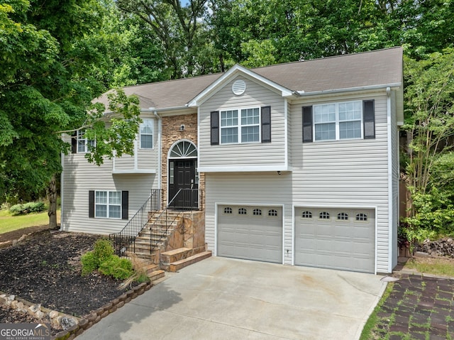 2623 Lone Oak Trl NW, Kennesaw, GA 30144 - raised ranch with a garage, concrete driveway, and view of wooded area