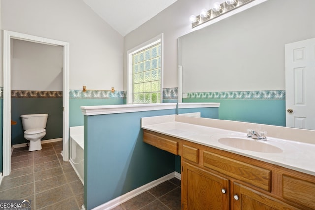 2623 Lone Oak Trl NW, Kennesaw, GA 30144 - full bath featuring vaulted ceiling, a bath, vanity, tile patterned flooring, and toilet