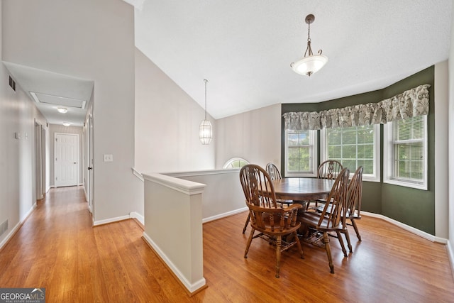 2623 Lone Oak Trl NW, Kennesaw, GA 30144 - dining room with light wood-style flooring, baseboards, and lofted ceiling