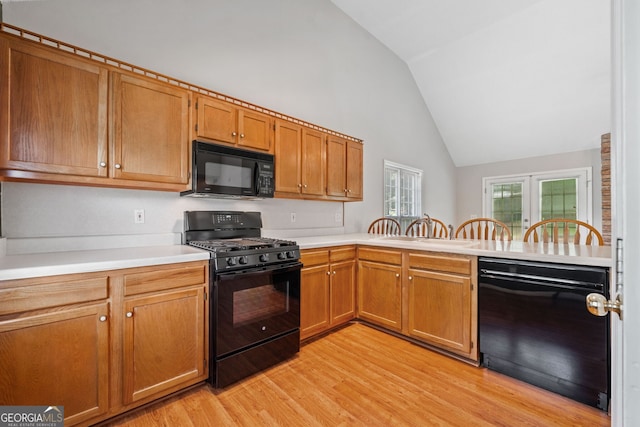 2623 Lone Oak Trl NW, Kennesaw, GA 30144 - kitchen featuring black appliances, light wood finished floors, light countertops, a peninsula, and brown cabinets
