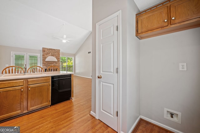 2623 Lone Oak Trl NW, Kennesaw, GA 30144 - kitchen with black dishwasher, a ceiling fan, a sink, light wood finished floors, and brown cabinets