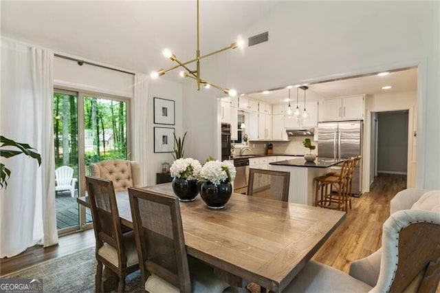 171 N Trce, Alpharetta, GA 30009 - dining area featuring a chandelier and wood finished floors