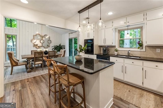 171 N Trce, Alpharetta, GA 30009 - kitchen with oven, a sink, white cabinetry, wood finished floors, and recessed lighting