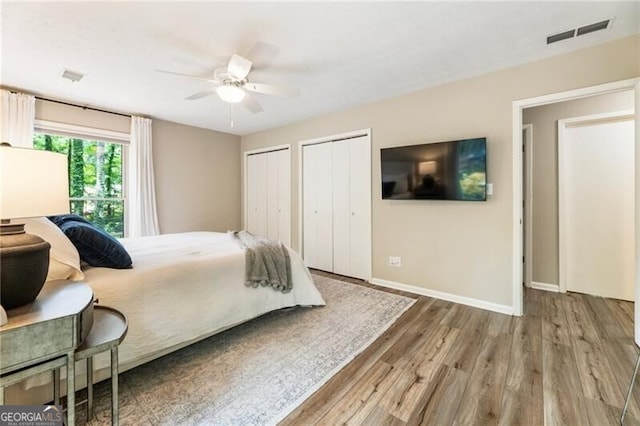171 N Trce, Alpharetta, GA 30009 - bedroom with two closets, wood finished floors, baseboards, and ceiling fan