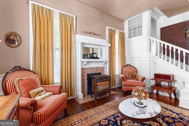 416 Engram St, Montezuma, GA 31063 - sitting room with wood-type flooring, stairway, and a brick fireplace