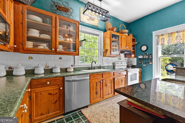 416 Engram St, Montezuma, GA 31063 - kitchen featuring dishwasher, white electric range oven, a sink, brown cabinetry, and glass insert cabinets