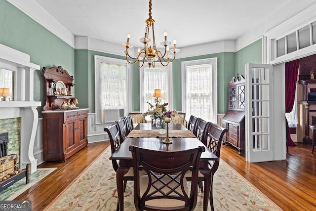 416 Engram St, Montezuma, GA 31063 - dining room featuring a chandelier, wood finished floors, a fireplace, and cooling unit