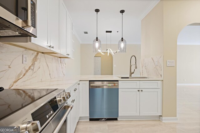 2499 Peachtree Rd Unit 506, Atlanta, GA 30305 - kitchen with appliances with stainless steel finishes, arched walkways, ornamental molding, decorative backsplash, and light stone countertops