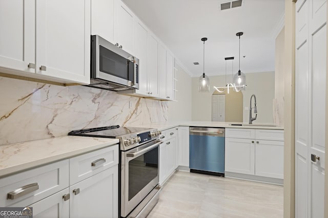 2499 Peachtree Rd Unit 506, Atlanta, GA 30305 - kitchen with appliances with stainless steel finishes, crown molding, backsplash, white cabinetry, and hanging light fixtures