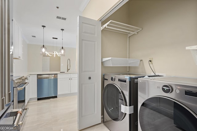 2499 Peachtree Rd Unit 506, Atlanta, GA 30305 - laundry area featuring washer and dryer and crown molding
