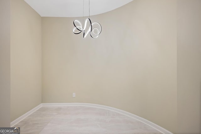 2499 Peachtree Rd Unit 506, Atlanta, GA 30305 - spare room featuring baseboards and a chandelier