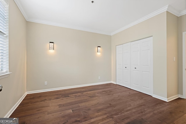 2499 Peachtree Rd Unit 506, Atlanta, GA 30305 - unfurnished bedroom with dark wood-style flooring, crown molding, and a closet