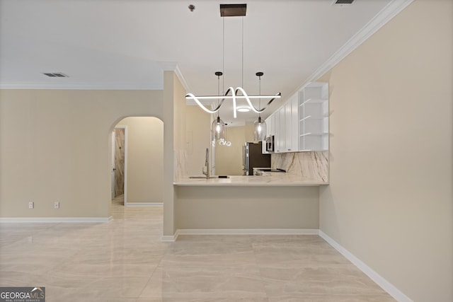 2499 Peachtree Rd Unit 506, Atlanta, GA 30305 - kitchen with arched walkways, open shelves, a chandelier, crown molding, and light countertops