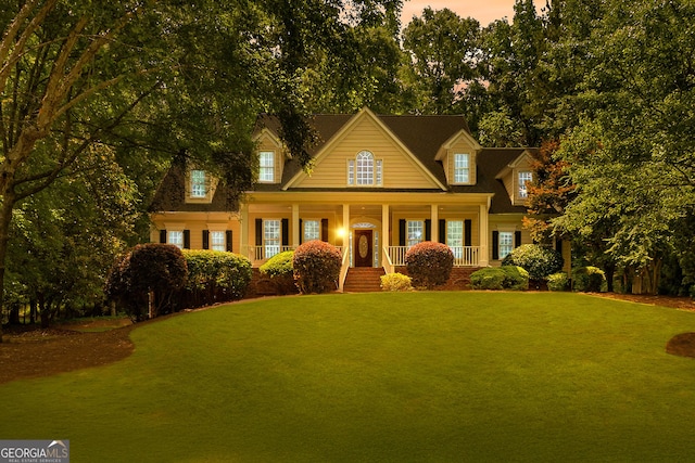 220 Broadmoor Dr, Fayetteville, GA 30215 - view of front facade with covered porch, a front lawn, and view of scattered trees