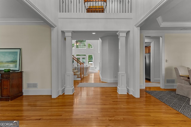 220 Broadmoor Dr, Fayetteville, GA 30215 - entryway with ornate columns, baseboards, light wood-style flooring, ornamental molding, and stairway