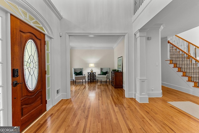 220 Broadmoor Dr, Fayetteville, GA 30215 - foyer featuring ornamental molding, decorative columns, light wood-style floors, baseboards, and stairs