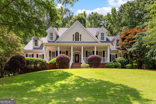 220 Broadmoor Dr, Fayetteville, GA 30215 - cape cod-style house featuring a porch and a front lawn