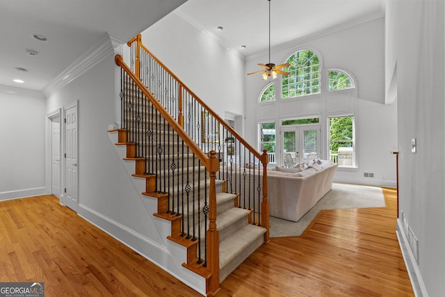 220 Broadmoor Dr, Fayetteville, GA 30215 - stairs with ceiling fan, wood finished floors, ornamental molding, baseboards, and a high ceiling
