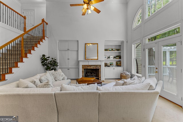 220 Broadmoor Dr, Fayetteville, GA 30215 - living area featuring a high ceiling, a ceiling fan, crown molding, stairway, and a stone fireplace