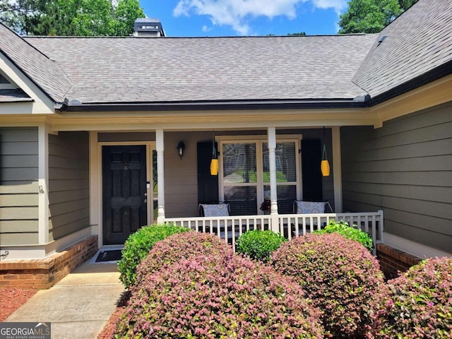 135 Pine Creek Way, Winterville, GA 30683 - view of exterior entry featuring roof with shingles, covered porch, and a chimney