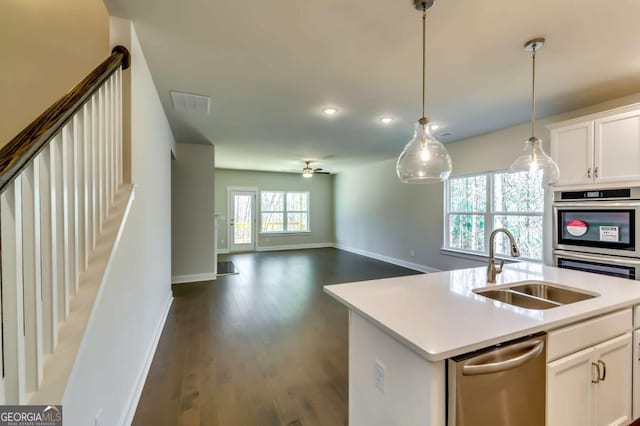 37 Radian Way, Dallas, GA 30132 - kitchen featuring stainless steel appliances, a sink, baseboards, dark wood-style flooring, and white cabinets