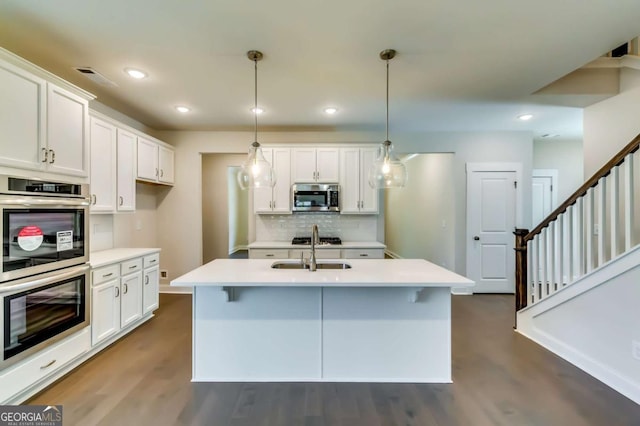 37 Radian Way, Dallas, GA 30132 - kitchen featuring stainless steel appliances, decorative backsplash, a sink, dark wood-type flooring, and white cabinetry