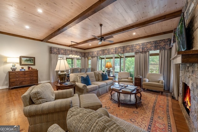 547 Toccoa River Ln, Mineral Bluff, GA 30559 - living room featuring a stone fireplace, hardwood / wood-style flooring, baseboards, ceiling fan, and wood ceiling with exposed beams