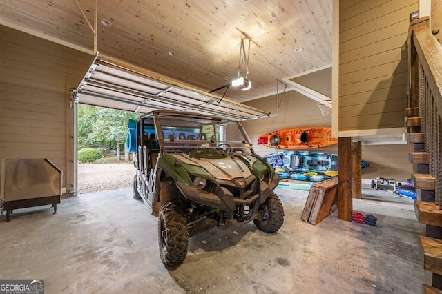 547 Toccoa River Ln, Mineral Bluff, GA 30559 - garage featuring wooden walls, a garage door opener, and wooden ceiling
