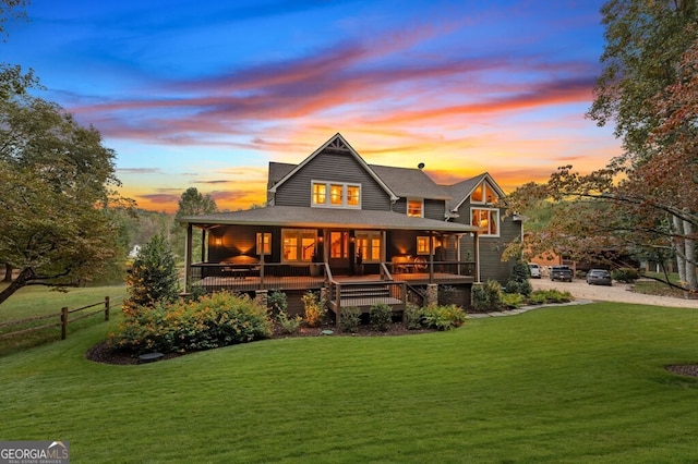547 Toccoa River Ln, Mineral Bluff, GA 30559 - back of property at dusk with covered porch and roof with shingles