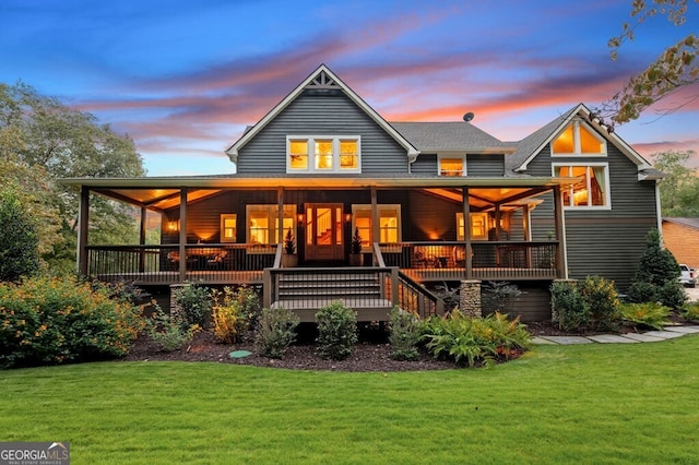 547 Toccoa River Ln, Mineral Bluff, GA 30559 - back of house at dusk with a lawn