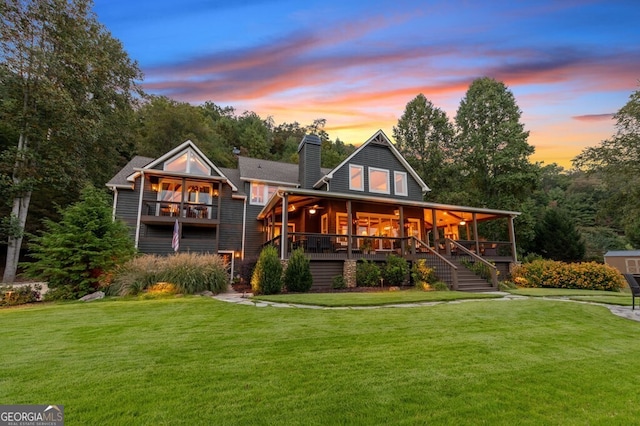 547 Toccoa River Ln, Mineral Bluff, GA 30559 - back of house at dusk with a chimney, stairway, and a lawn