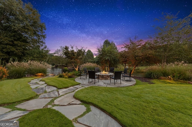 547 Toccoa River Ln, Mineral Bluff, GA 30559 - view of green lawn with an outdoor fire pit and a patio