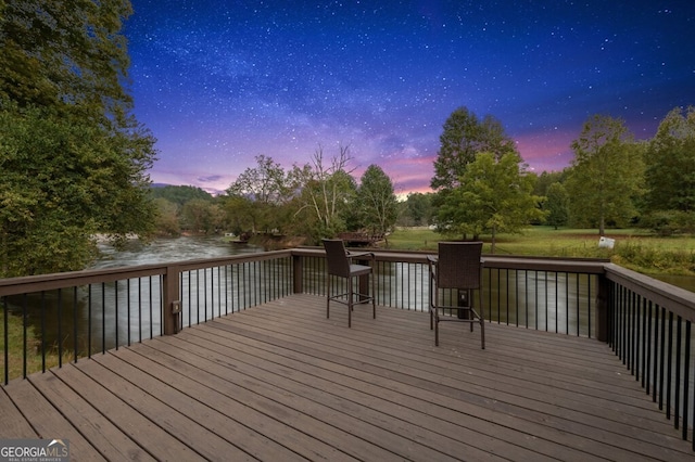 547 Toccoa River Ln, Mineral Bluff, GA 30559 - deck at dusk with a water view and view of scattered trees