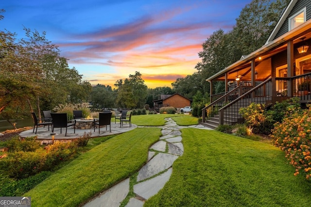 547 Toccoa River Ln, Mineral Bluff, GA 30559 - yard at dusk featuring an outdoor fire pit, a patio area, stairway, and a lawn