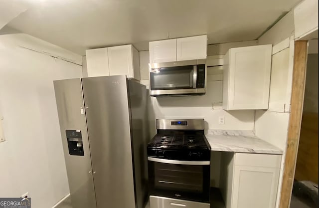8020 Ga Highway 272, Sandersville, GA 31082 - kitchen featuring stainless steel appliances, white cabinets, and light stone countertops