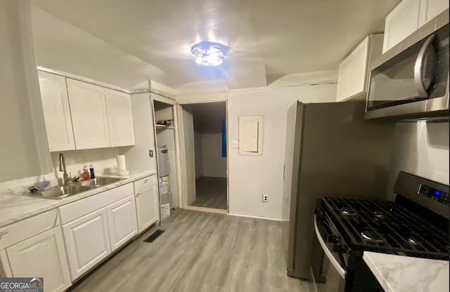 8020 Ga Highway 272, Sandersville, GA 31082 - kitchen with stainless steel appliances, a sink, white cabinetry, electric panel, and light countertops