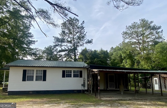 8020 Ga Highway 272, Sandersville, GA 31082 - rear view of property with crawl space, metal roof, an attached carport, and driveway