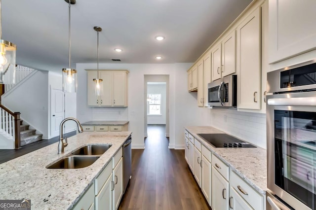537 Principal Meridian Dr, Dallas, GA 30132 - kitchen with stainless steel appliances, a sink, tasteful backsplash, recessed lighting, and hanging light fixtures