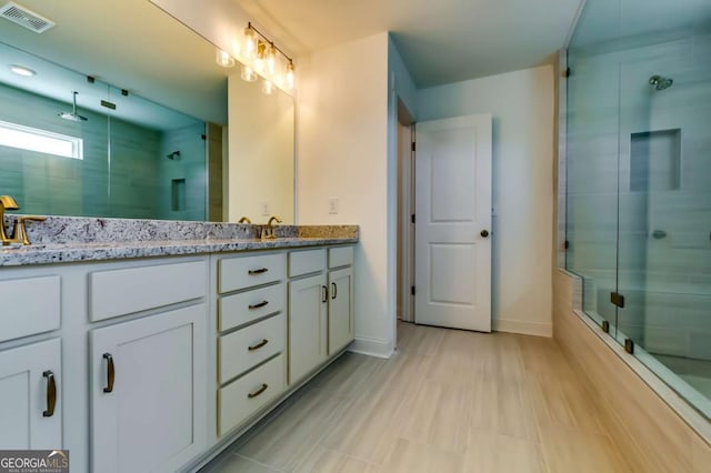 537 Principal Meridian Dr, Dallas, GA 30132 - full bathroom featuring a tile shower, double vanity, and baseboards