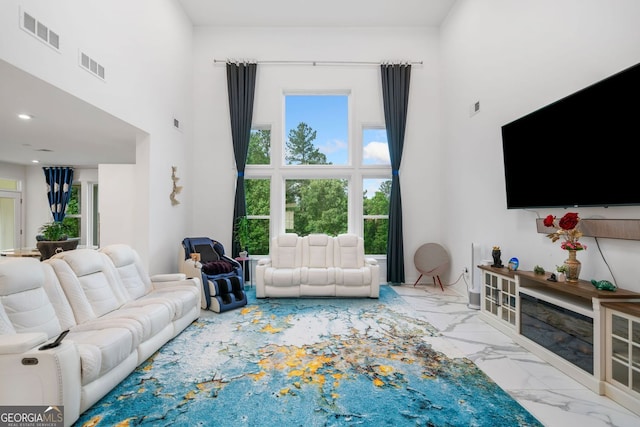 2121 Harmony Dr, Canton, GA 30115 - living area featuring a towering ceiling, marble finish flooring, healthy amount of natural light, and recessed lighting