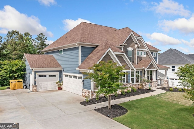 2121 Harmony Dr, Canton, GA 30115 - craftsman house with driveway, stone siding, an attached garage, a front lawn, and roof with shingles