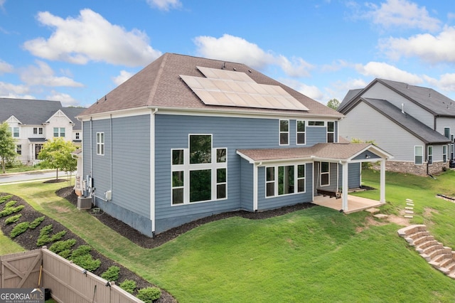 2121 Harmony Dr, Canton, GA 30115 - rear view of house featuring a patio area, roof mounted solar panels, a yard, and a shingled roof