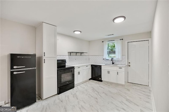 1268 Ladd St SW, Atlanta, GA 30310 - kitchen with black appliances, backsplash, white cabinetry, light countertops, and a sink