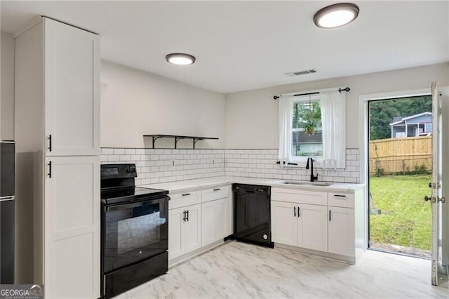 1268 Ladd St SW, Atlanta, GA 30310 - kitchen featuring black appliances, light countertops, a sink, and white cabinets
