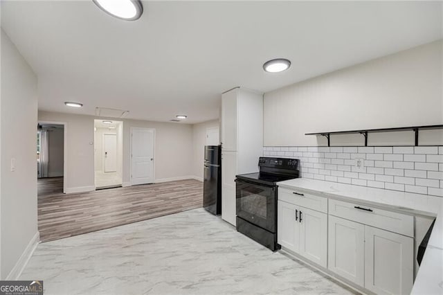 1268 Ladd St SW, Atlanta, GA 30310 - kitchen with black appliances, decorative backsplash, white cabinets, light countertops, and baseboards