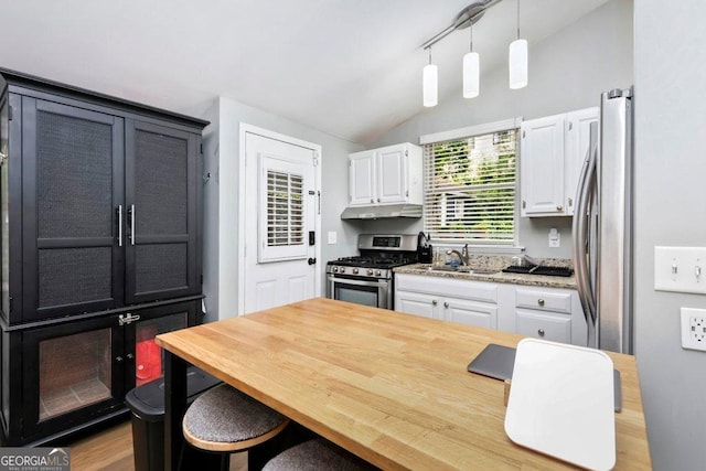 677 Holmes St NW, Atlanta, GA 30318 - kitchen featuring stainless steel appliances, white cabinetry, lofted ceiling, pendant lighting, and under cabinet range hood